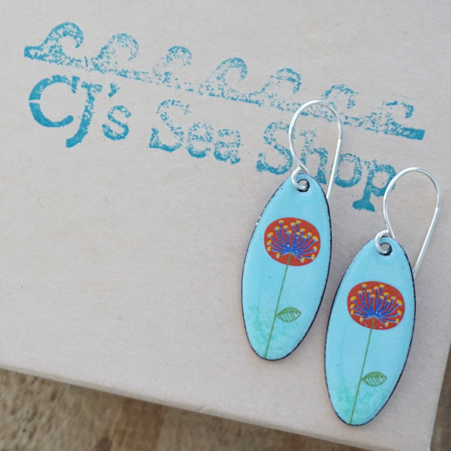 CLEARANCE Red and Blue Dandelions on Light Blue Oval Earrings