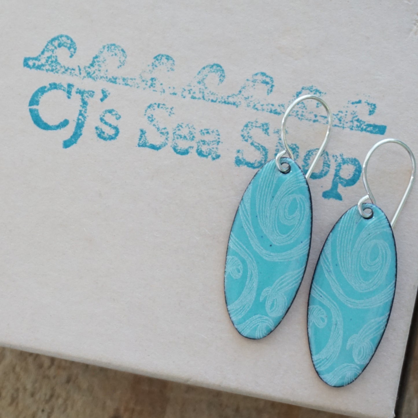 White Swirls on Light Teal Green Enamel Oval Earrings