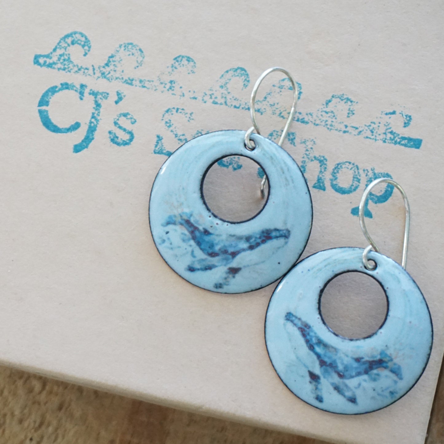 Blue circular earrings on a gift box