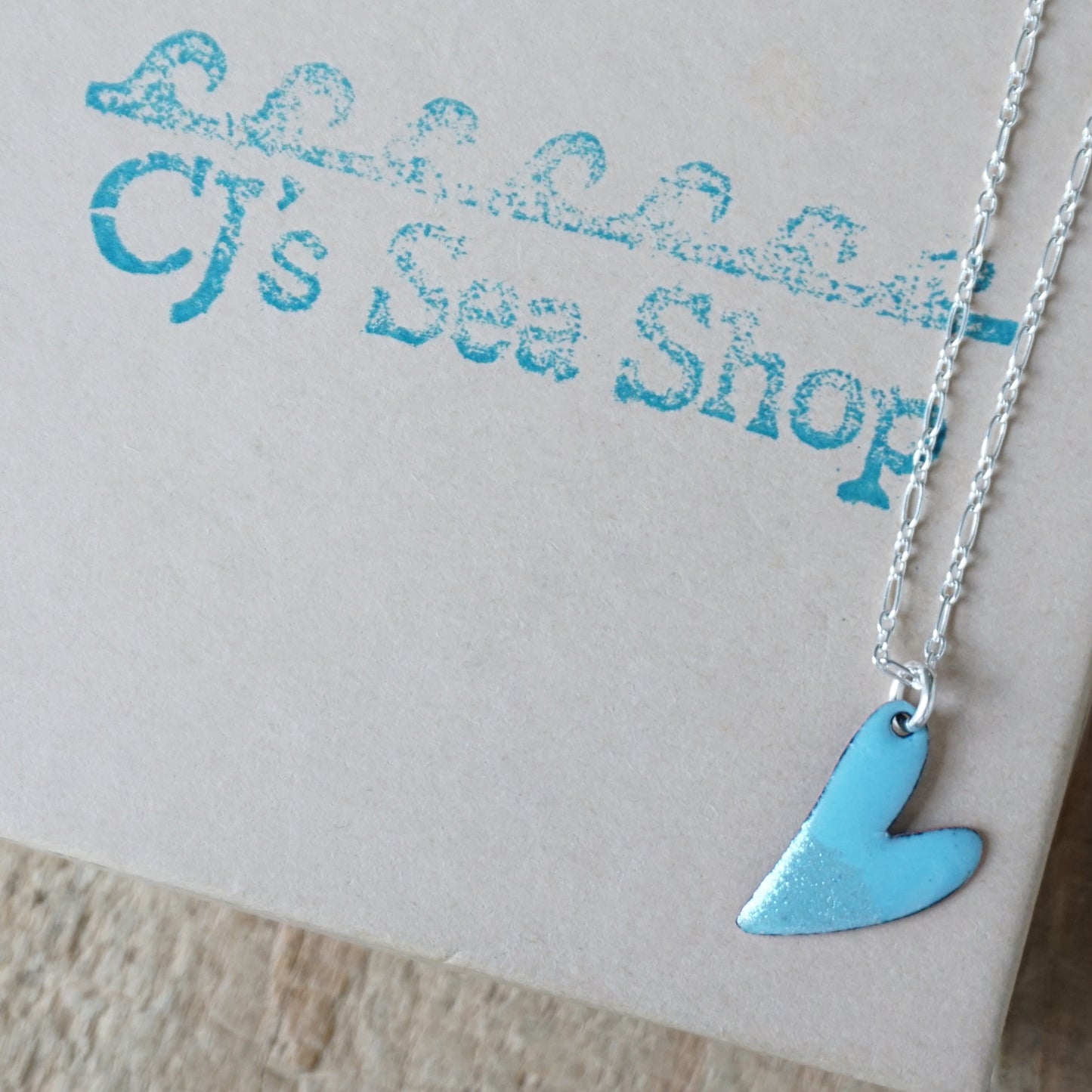 blue heart pendant on a gift box