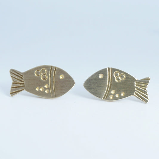 Gold fish-shaped earrings on a white background