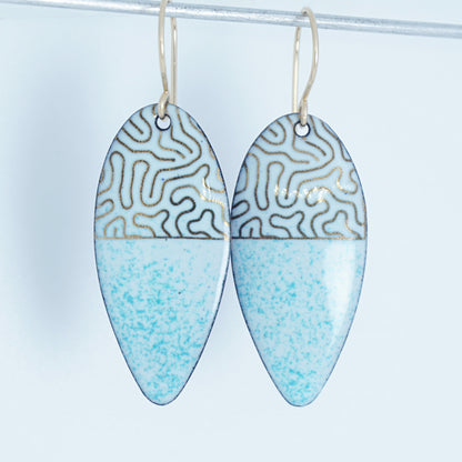 gold pattern on seafoam green enamel teardrop shaped earrings, on a white background