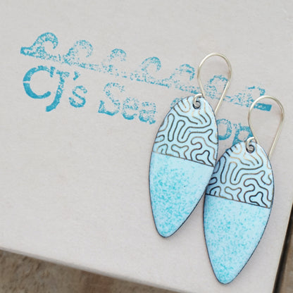 gold pattern on seafoam green enamel teardrop shaped earrings, on a gift box
