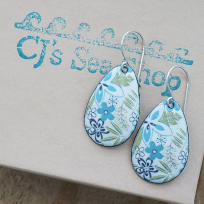Teardrop-shaped earrings with a blue and green floral pattern on a white background, displayed on a gift box