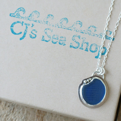 sterling silver and cobalt blue sea glass pendant, displayed on a gift box
