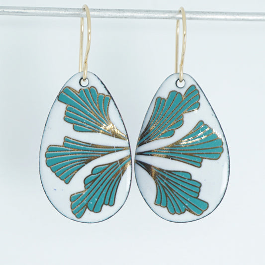 Teardrop shaped enamel earrings with green and gold leaves, against a white background