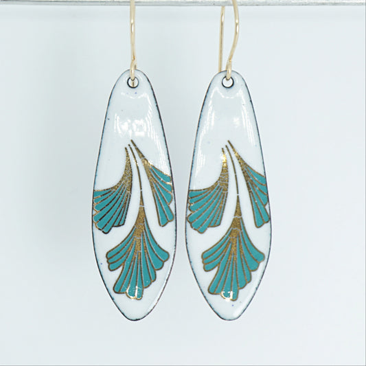 Teardrop shaped enamel earrings with green and gold leaves, against a white background