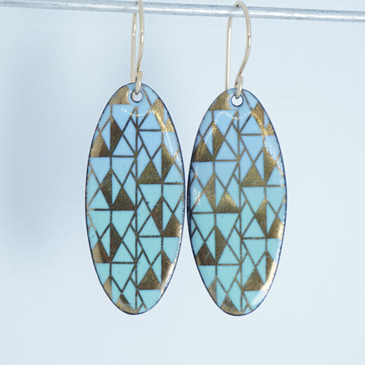 a pair of light blue and green enamel earrings with gold designs, against a white background