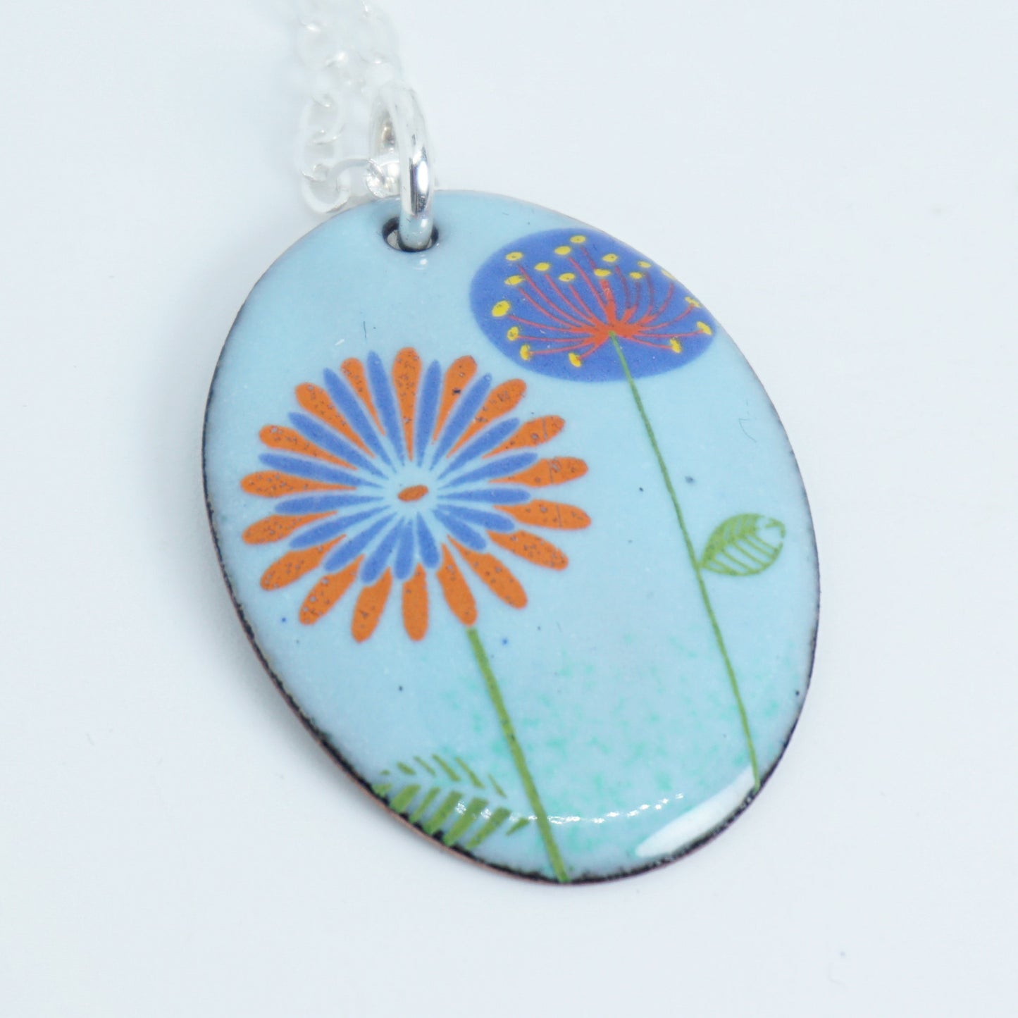 Red Daisy and Purple Dandelion on Light Blue Enamel Oval Pendant