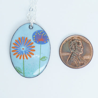 Red Daisy and Purple Dandelion on Light Blue Enamel Oval Pendant