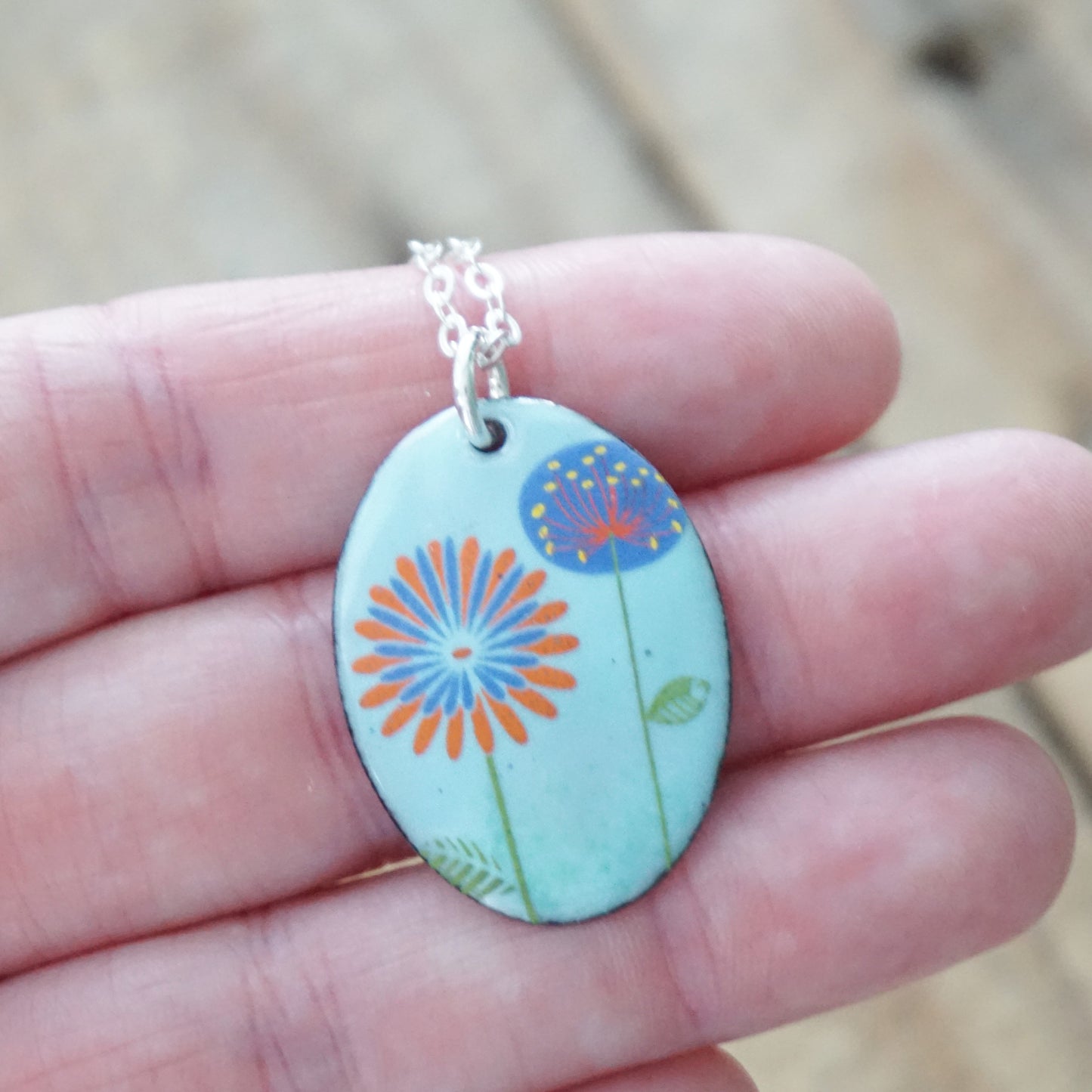 Red Daisy and Purple Dandelion on Light Blue Enamel Oval Pendant