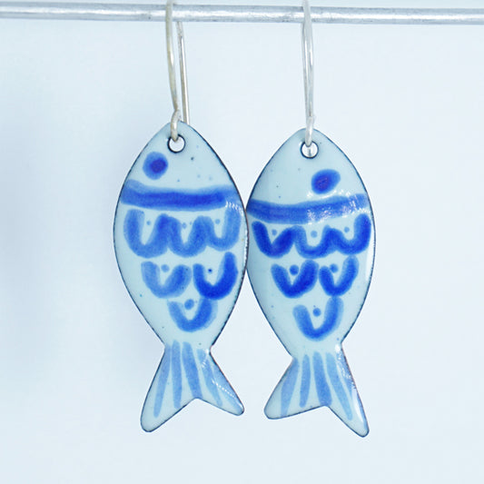 light green and blue enamel fish shaped earrings, against a white background