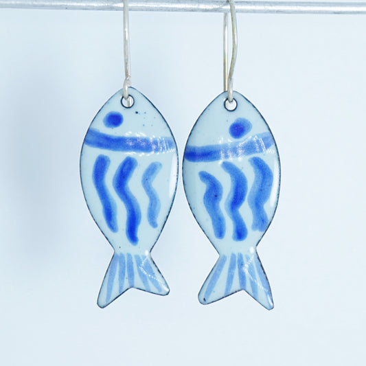 light green and blue enamel fish shaped earrings, against a white background