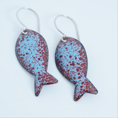 light blue and red enamel fish shaped earrings, against a white background