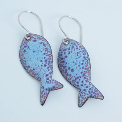 light blue and purple enamel fish shaped earrings, against a white background