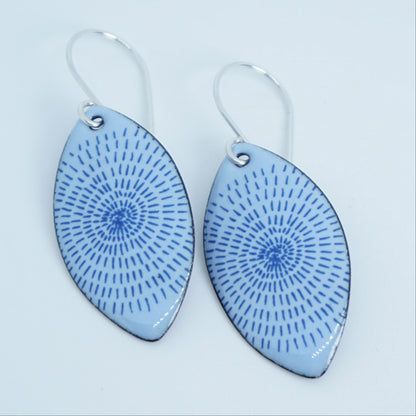 a pair of light purple enamel marquis shaped earrings with blue accents, against a white background