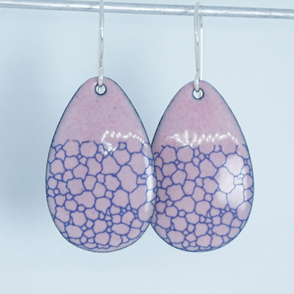 a pair of pink enamel teardrop shaped earrings with blue bubble accents, against a white background