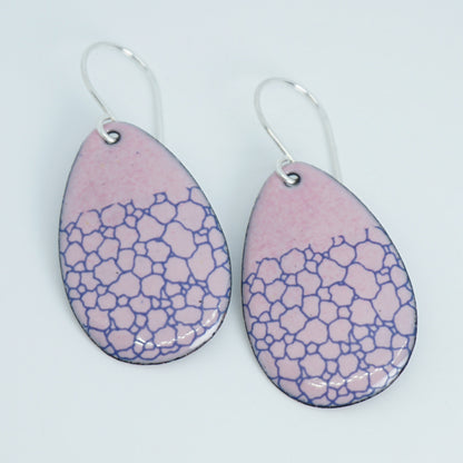 a pair of pink enamel teardrop shaped earrings with blue bubble accents, against a white background