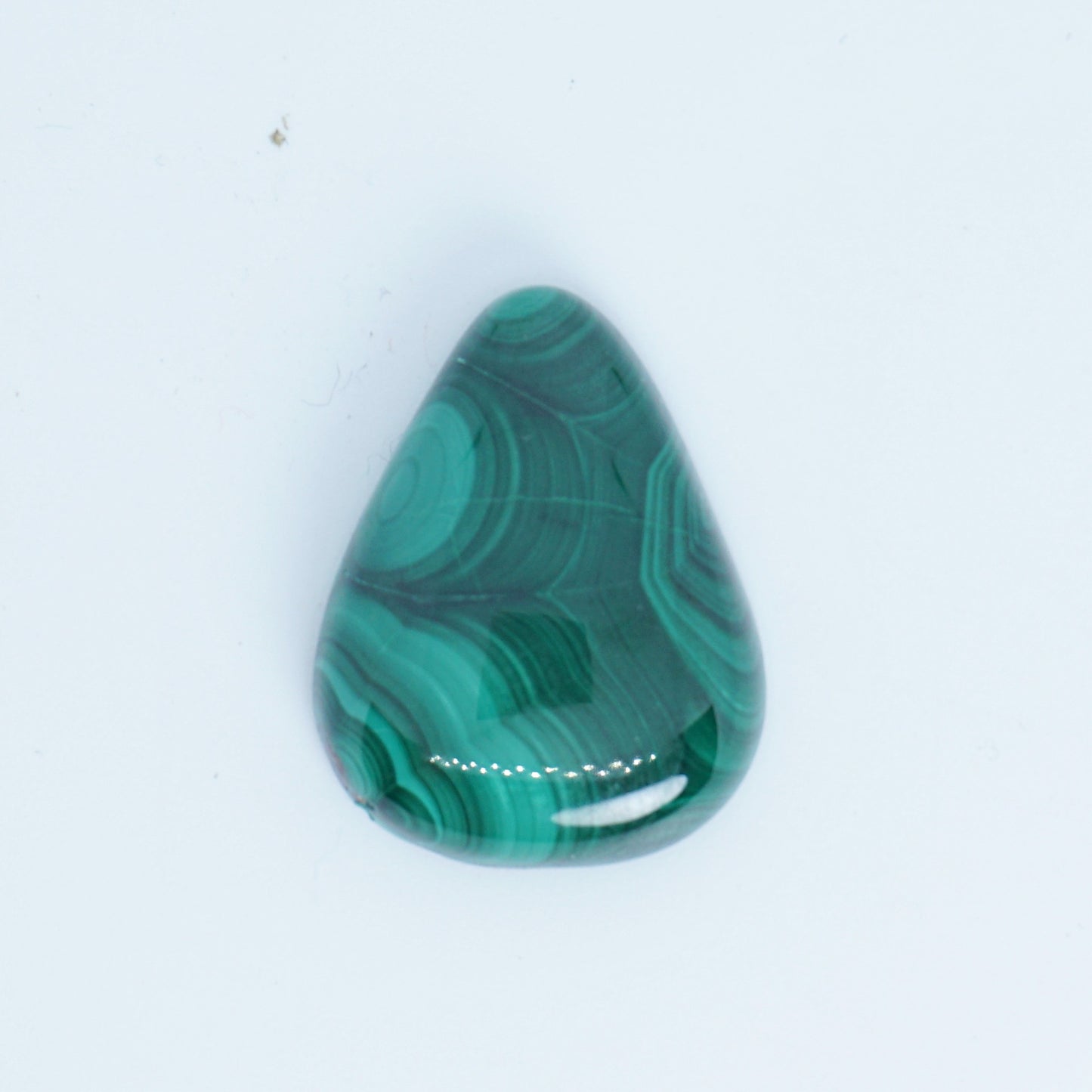Teardrop-shaped green malachite stone on a white background