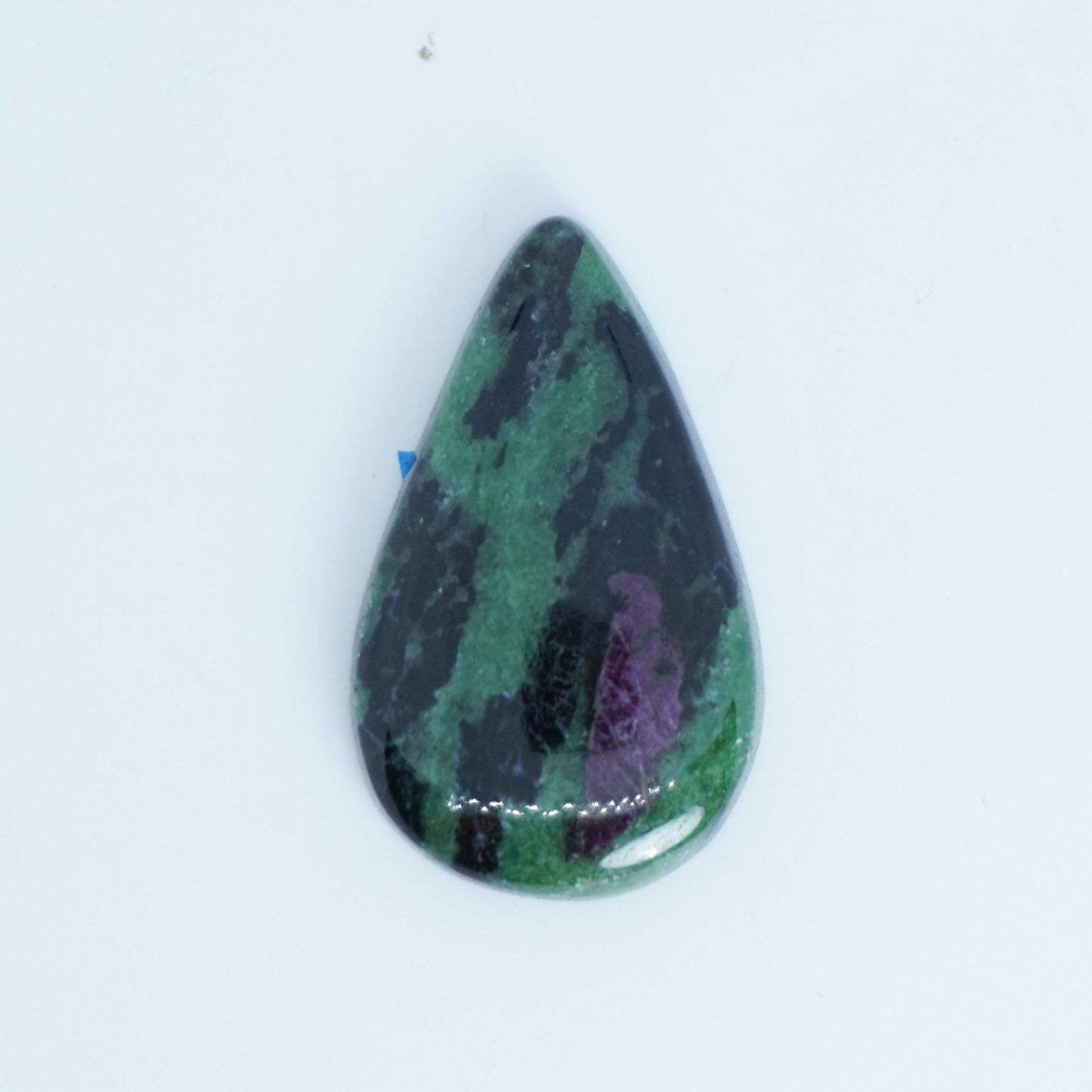 Teardrop-shaped gemstone with green and purple patterns on a white background