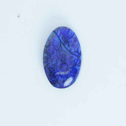 Oval-shaped blue lab created opal on a white background
