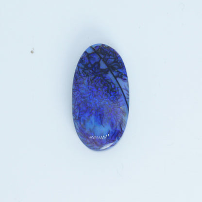 Oval-shaped blue lab created opal with a white background