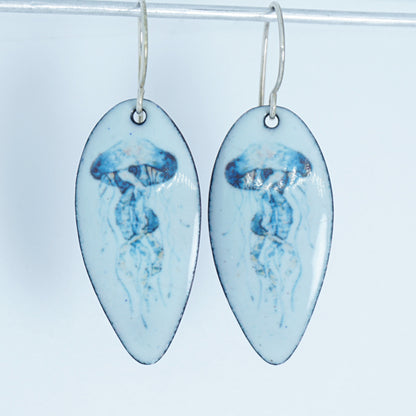 teardrop shaped earrings with jellyfish design on a white background
