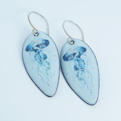 Pair of earrings with blue jellyfish design on white background