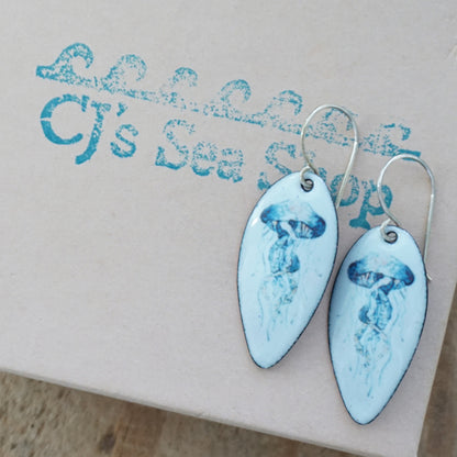 seafoma green teardrop-shaped earrings with a jellyfish desing on a gift box
