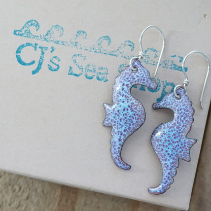 Seahorse-shaped earrings on a gift box