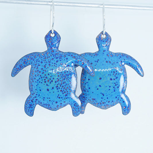 blue turtle-shaped earrings on a white background