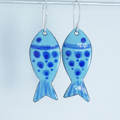 Pair of fish-shaped earrings with blue pattern on a white background