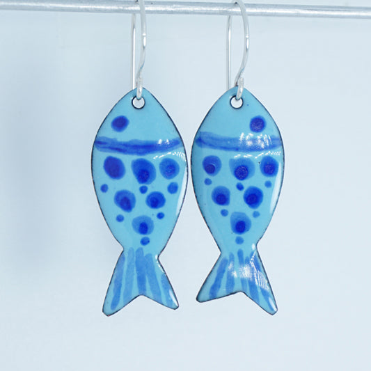 Pair of fish-shaped earrings with blue pattern on a white background