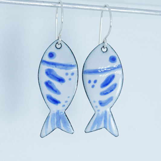 Fish-shaped earrings with blue patterns on a white background