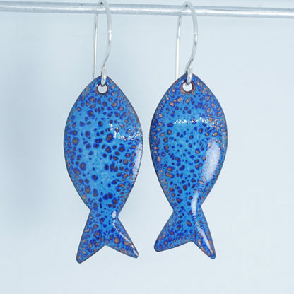 blue enamel fish shaped earrings on a white background