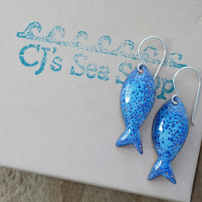 Blue fish-shaped earrings on a gift box