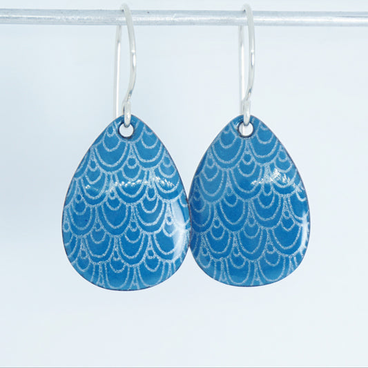 Teardrop-shaped earrings with blue and white pattern on a white background