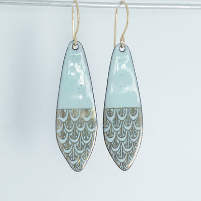 Pair of earrings with light green and gold patterned design on a white background
