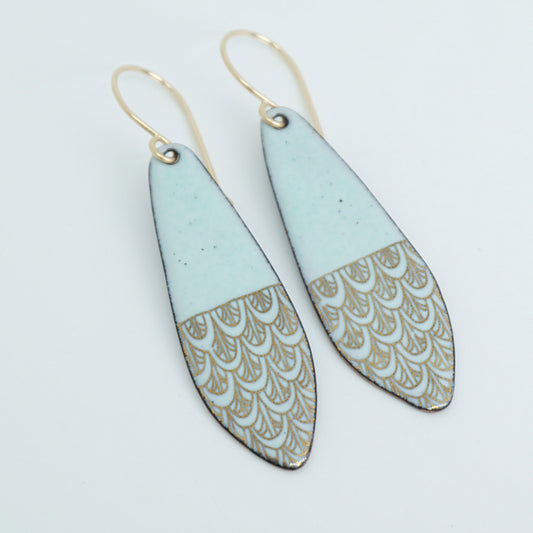 Pair of earrings with light green and gold patterned design on a white background