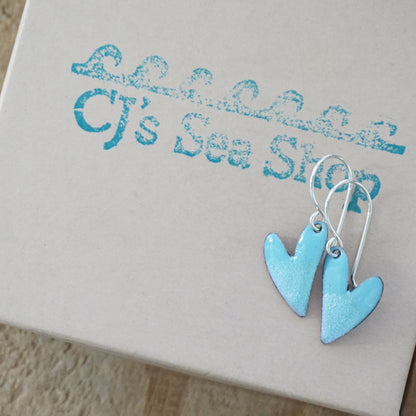 Blue heart-shaped earrings on a gift box