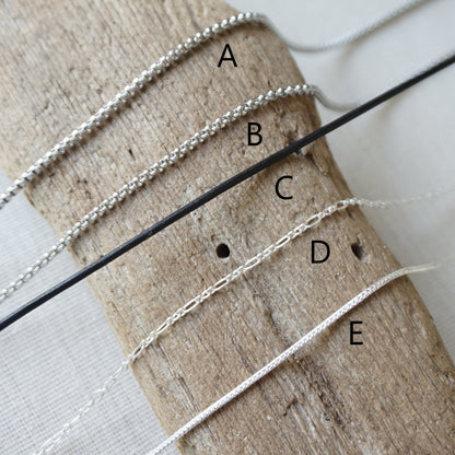 Five different chain options. Materials include stainless, leather, and sterling silver