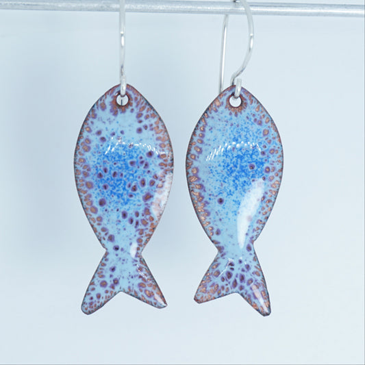 Fish-shaped earrings with a speckled design on a white background