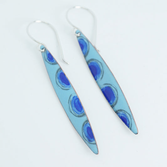 Pair of long, light blue earrings on a white background