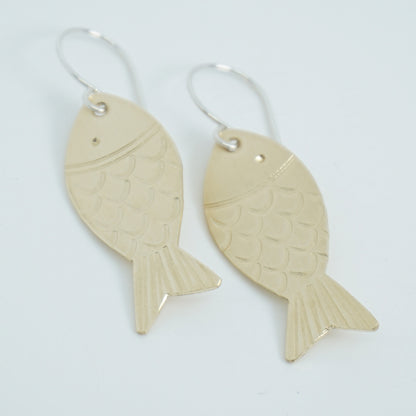 brass Fish-shaped earrings on a white background