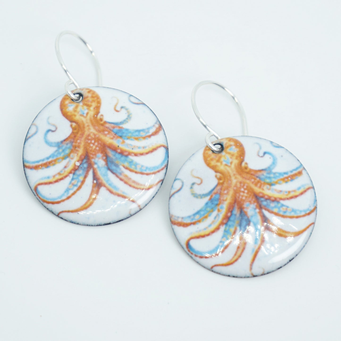 Pair of earrings with octopus design on a white background