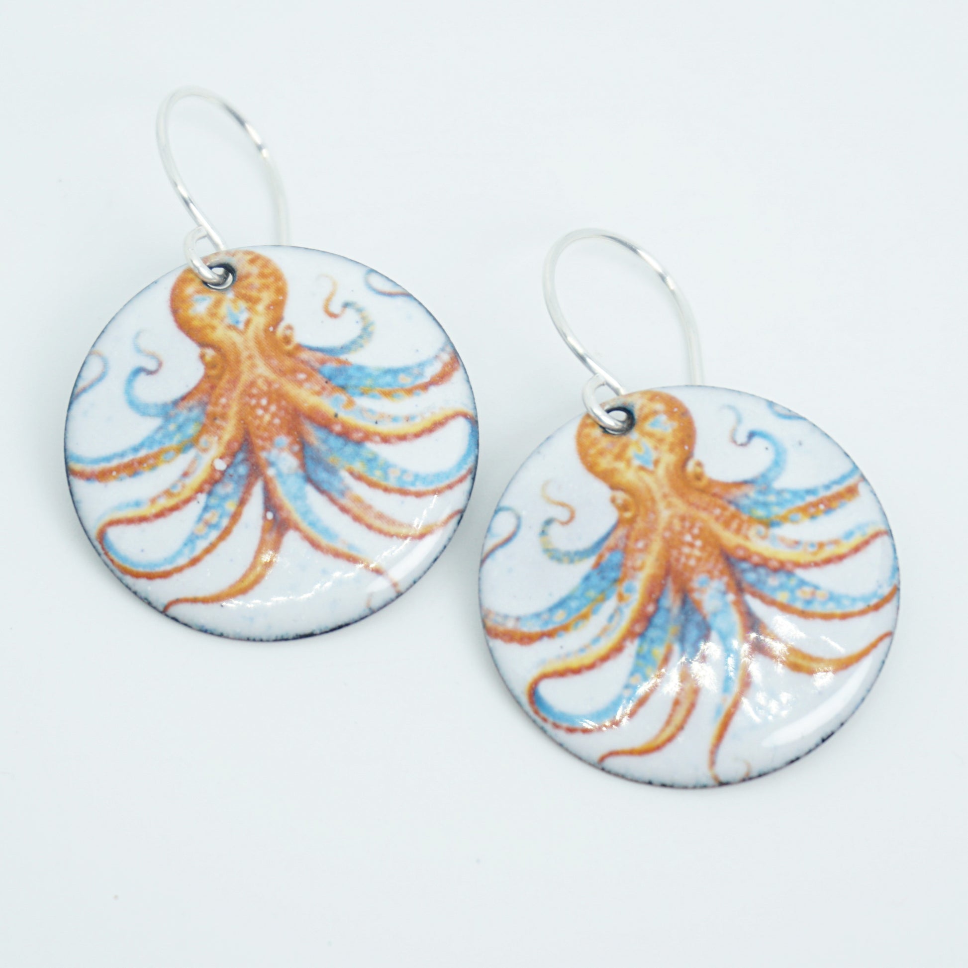 Pair of earrings with octopus design on a white background