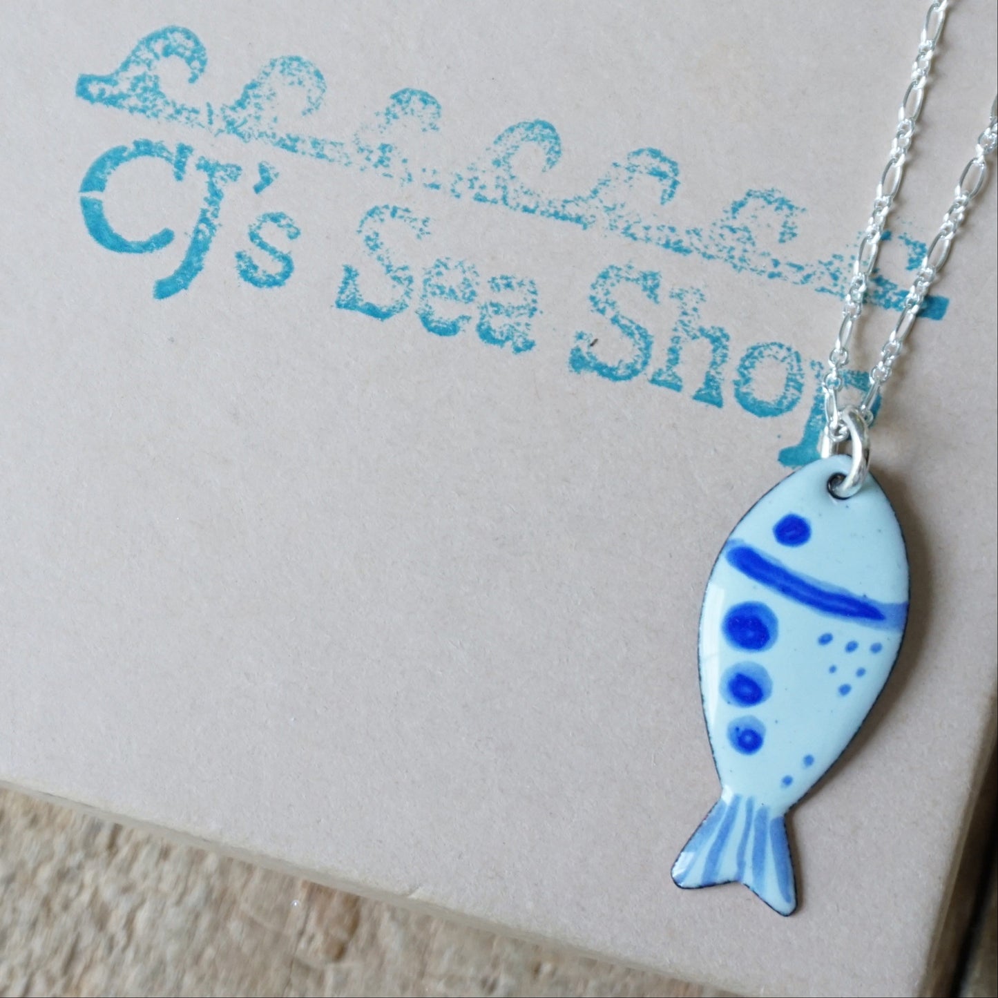 fish-shaped pendant on a gift box