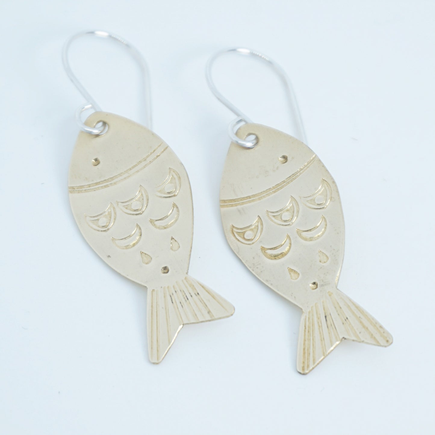 Fish-shaped earrings on a white background