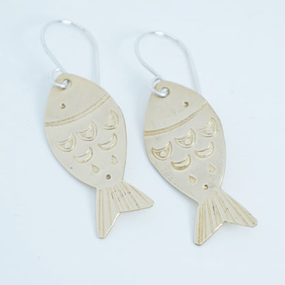 Fish-shaped earrings on a white background