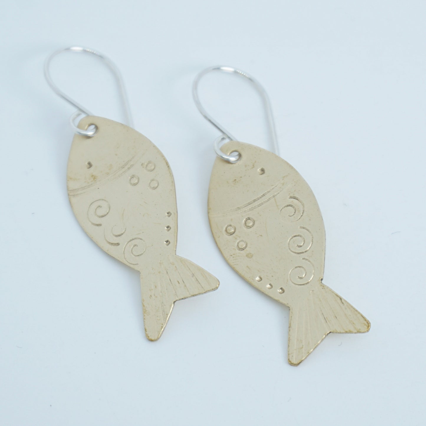 Fish-shaped earrings on a white background